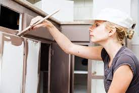 Painting Kitchen Cabinets - Woman Painting Cabinet